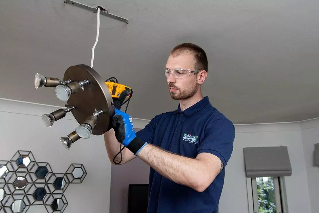 Professional electrician replaces light fitting