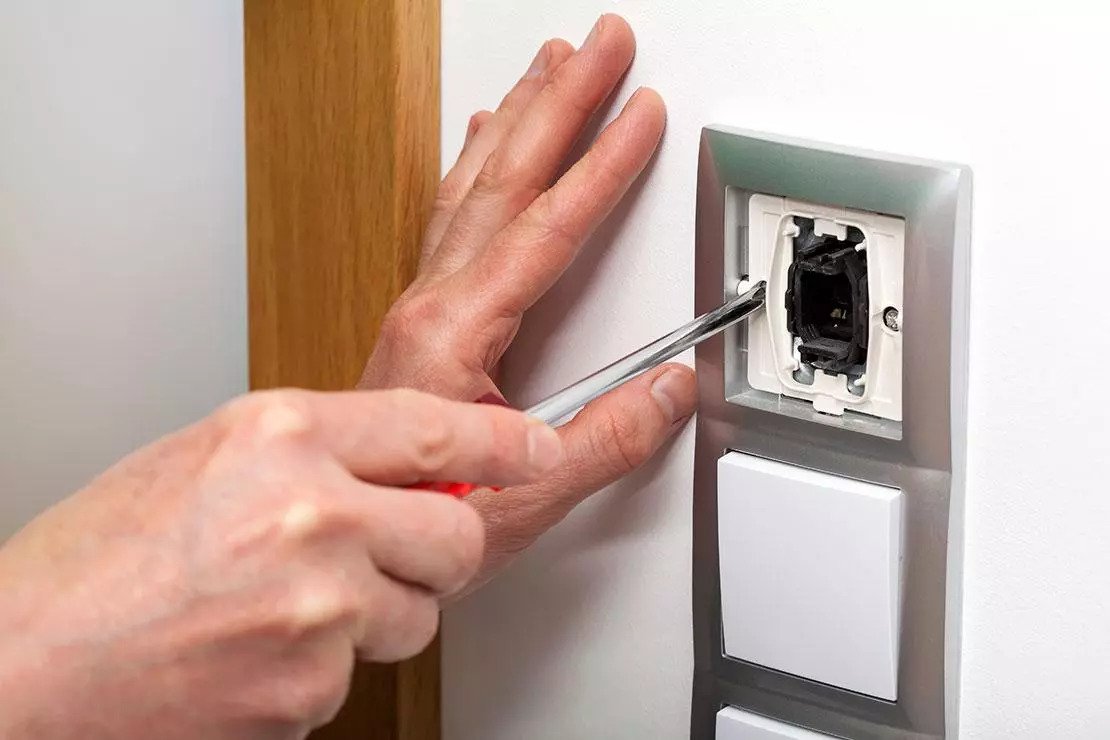 Electrician installing light switches and sockets
